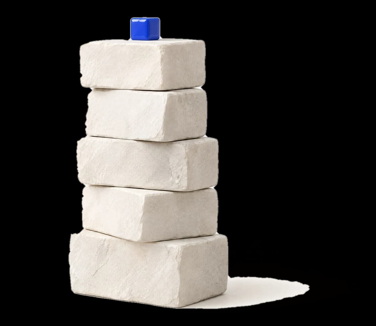 Five white stone blocks stacked, a cobalt cube on top